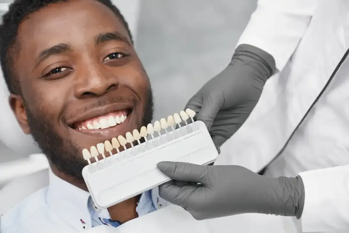 Man smiling as dentist inspects his teeth